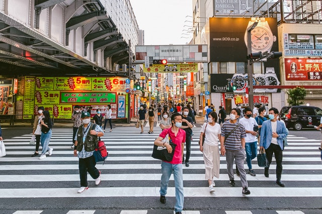 Japanese people on a crossroad in one of the best japan destinations for freelance writers.