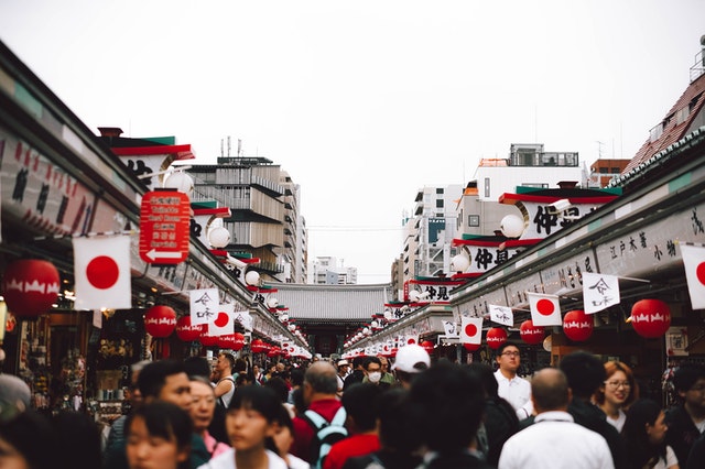 Japanese flags and crowds in Tokyo.