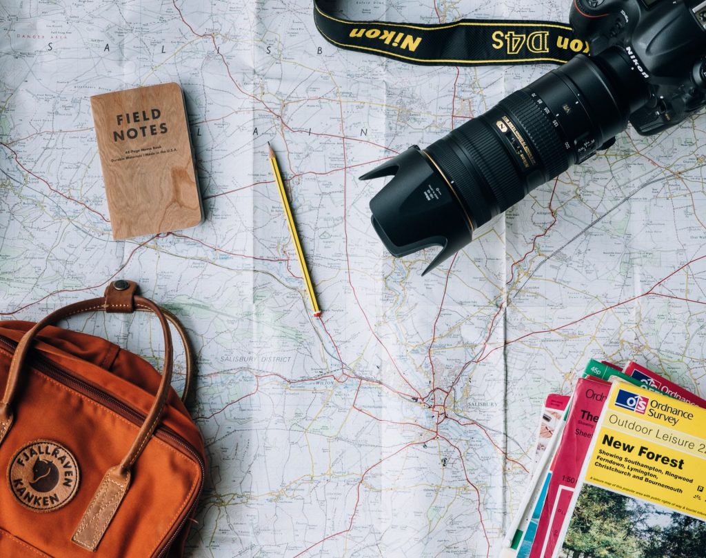A map, brochures, a bag, and a camera