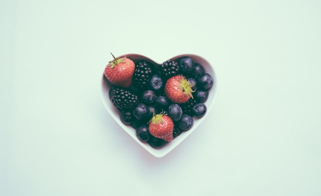 A heart-shaped bowl of berries