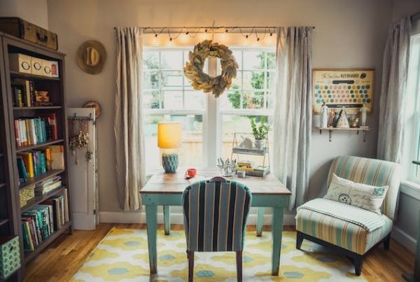 A cozy and inviting home office space with a striped chair, colorful decor, and a personal library.